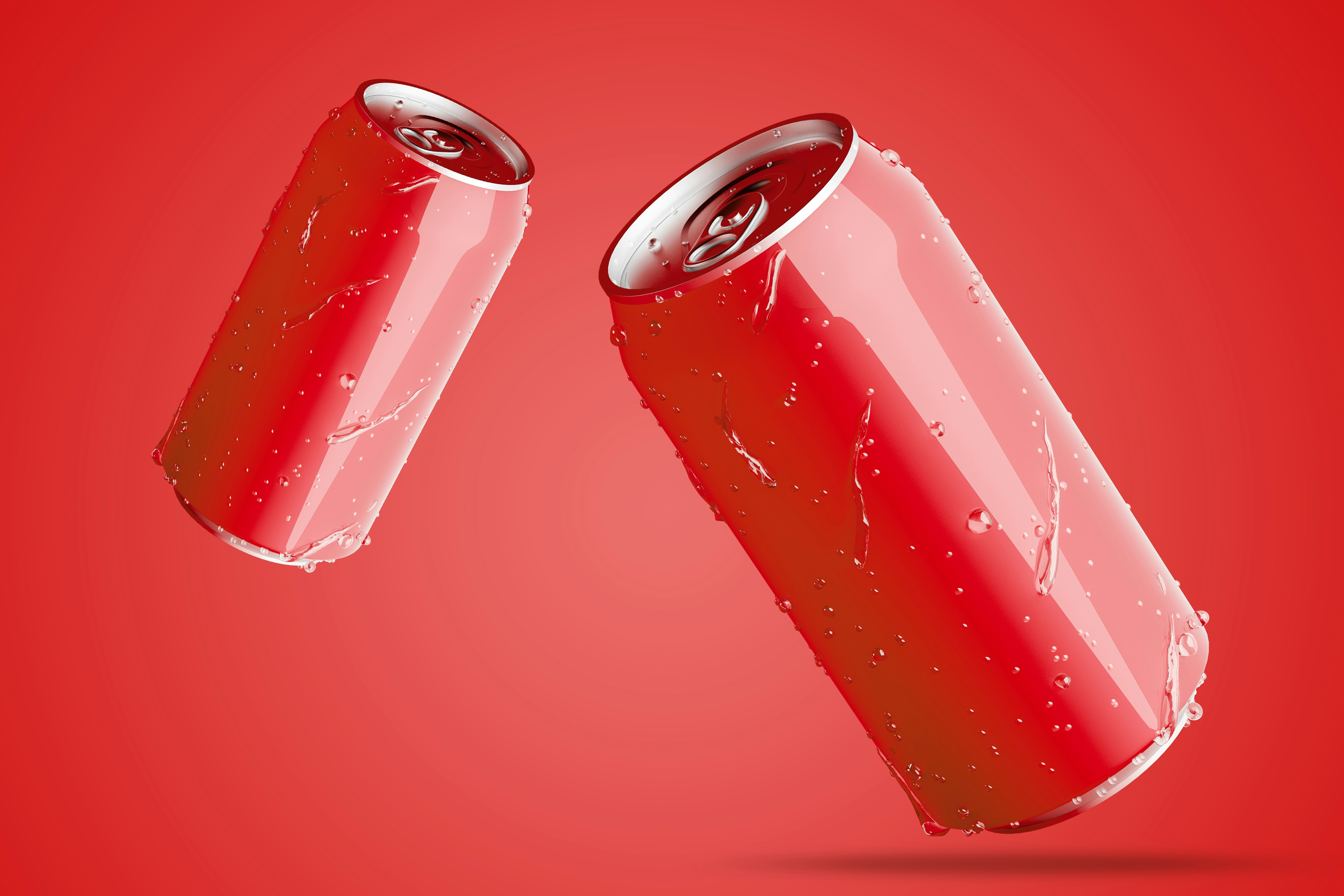 Red soft drinks cans flying in the air over red background